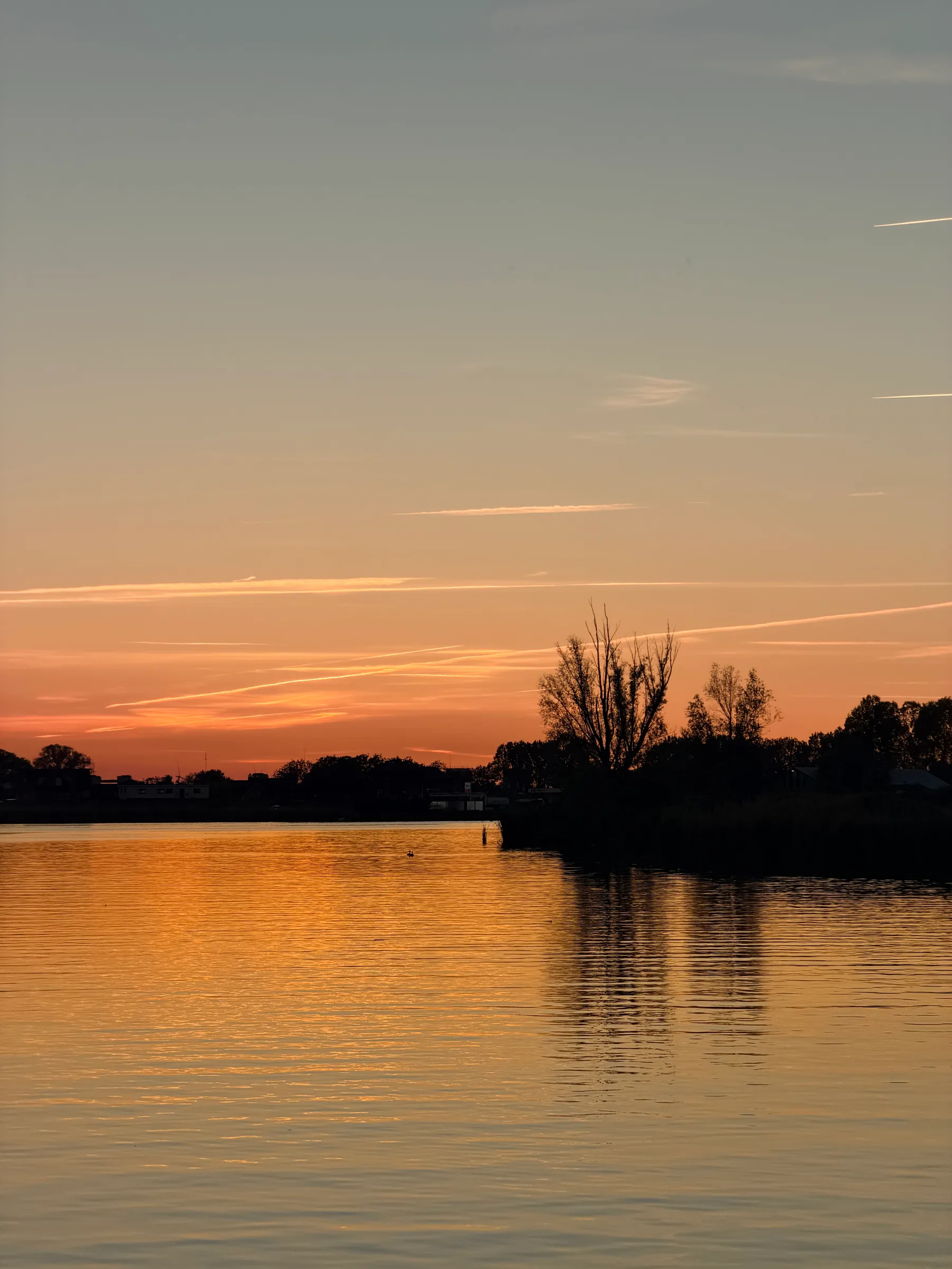 Sunset over the Maas near the harbour of Lithoijen