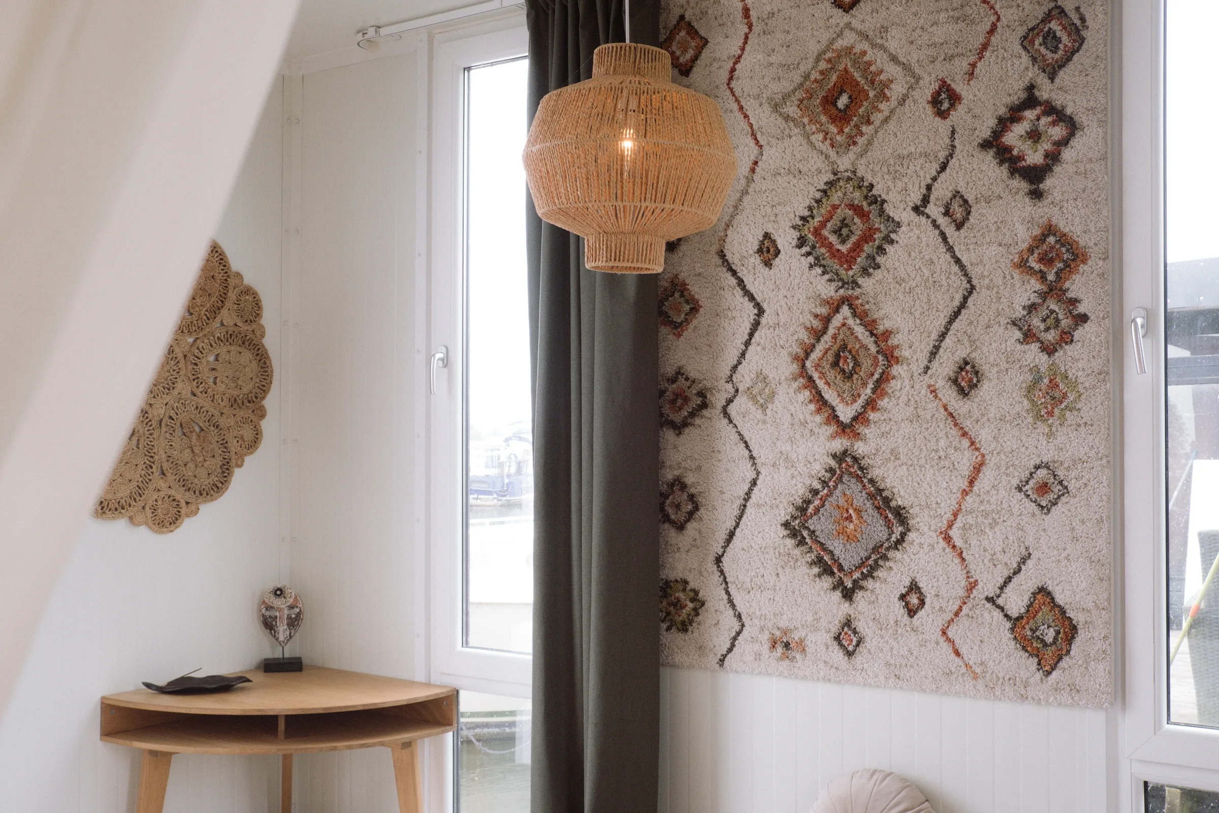 A corner with rug and lamp